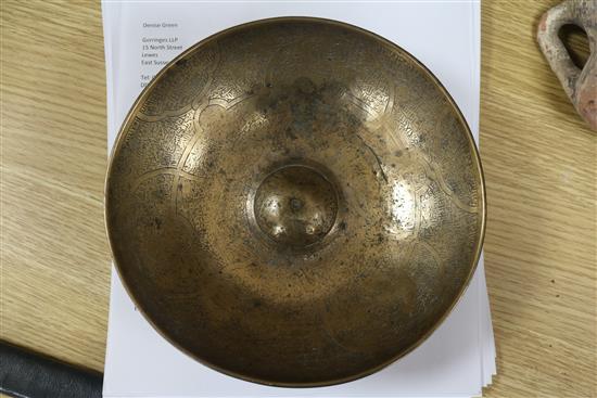 An Islamic bronze magic bowl with incised Koranic inscriptions within geometric motifs, Dia 7.5in (wear to interior)